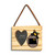 A rectangular wood hanging ornament with a 2x2 inch heart shaped photo opening next to an image of a black bear peeking over a wood stump with North Dakota on it, displayed angled to the left.
