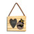 A rectangular wood hanging ornament with a 2x2 inch heart shaped photo opening next to an image of a black bear peeking over a wood stump with North Carolina on it, displayed angled to the left.
