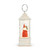 Profile view of a white lit musical lantern with a Santa figure inside holding a small tree.