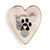 Heart shaped ceramic dish with a gold rim. The interior has a paw print and says "Loyal at Heart", displayed with a ring and necklace inside.