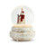 Left profile view of a lit snow globe with a rough white wood base. Inside the snow globe is a knit snowman in a red scarf and Santa hat holding a stocking next to a white tree with gold star at the top.