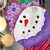 Close up of a snowman screen door hanger in shades of purple and pink.