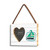 A rectangular hanging white wood frame ornament with a graphic image of a green sailboat with a 2x2 heart shaped opening for a photo, displayed angled to the left.