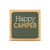 A square wood plaque with a dark green tile that says "Happy Camper".