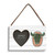 A rectangular hanging white wood frame ornament with a graphic image of a green horned animal skull and a 2x2 heart shaped opening for a photo.
