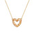 Detail view of the charm on a gold chain necklace with a heart shaped charm filled with small cream stones.