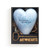 A light blue heart shaped sculpture that says "two hearts become one" with two white overlapping hearts. The heart has a silver tassel and gold key attached, displayed in a dark gray packaging box.