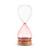 A glass sand timer with pink glass on the bottom half sitting in a wood base that reads "grandma & me time".