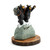 A figurine of two black bears wearing backpacks on the top of a snowy mountain that says "The Summit", on a base that looks like a wood stump, displayed angled to the right.