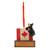 A hanging ornament of a black bear hugging the Canadian Flag.