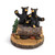 A sculpted figurine of a family of black bears on a wood log. The base has a rectangular space for personalization.