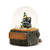 A glass snow globe with a sitting black bear next to a pine tree. The base is sculpted like a tree trunk and has a rectangular space for personalization, displayed angled to the left.