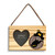 A rectangular wood hanging ornament with a 2x2 inch heart shaped photo opening next to an image of a black bear peeking over a wood stump with West Virginia on it.