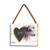 A rectangular wood hanging frame with a heart shaped 2 inch photo opening next to a watercolor image of a cow, displayed angled to the left.