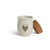 A cream ceramic candle with a gray heart and the word "friends". The candle has a cork lid, displayed off and leaning against the side of the candle.