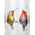 Detail view of the hummingbirds on a white tubular ceramic wind chime with a wood chime. There are watercolor hummingbirds on a wire around the outside.