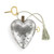 A silver heart shaped musical sculpture with a heart pattern that reads "You Fill My Heart With Love". The heart has a silver tassel and gold key attached.