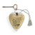 Heart shaped sculpture with a silver tassel and metal key attached. The heart has the image of Pooh eating honey on a brown background and says "I wouldn't trade you for all the hunny in the world".