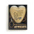 Heart shaped sculpture with a silver tassel and metal key attached. The heart has the image of Pooh eating honey on a brown background and says "I wouldn't trade you for all the hunny in the world", displayed in a packaging box.