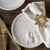 Top down of a table set with ceramic appetizer plates with nativity scenes and gold star of Bethlehem napkin holders.