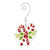 A glass ornament of two crossed candy canes and holly leaves with a curved silver hanger, displayed angled to the right.