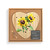 A wood heart shaped peg game with a watercolor image of yellow sunflowers, displayed in a packaging box.
