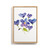 A light wood framed wall art of watercolor violets.
