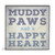 A square gray wall art with the saying "Muddy paws and a happy heart".