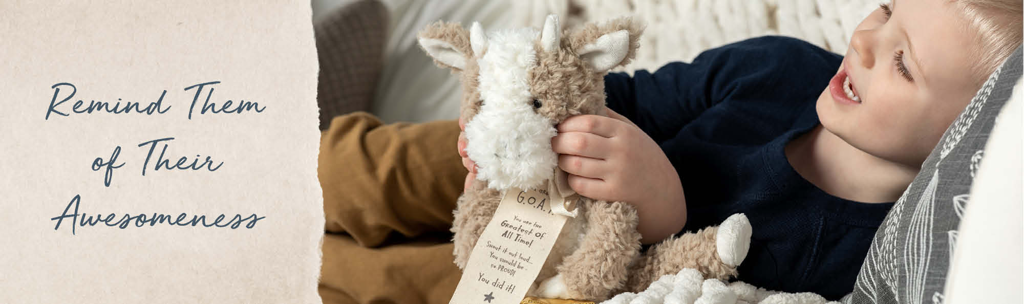 Remind Them of Their Awesomeness. Boy playing with a stuffed goat toy.