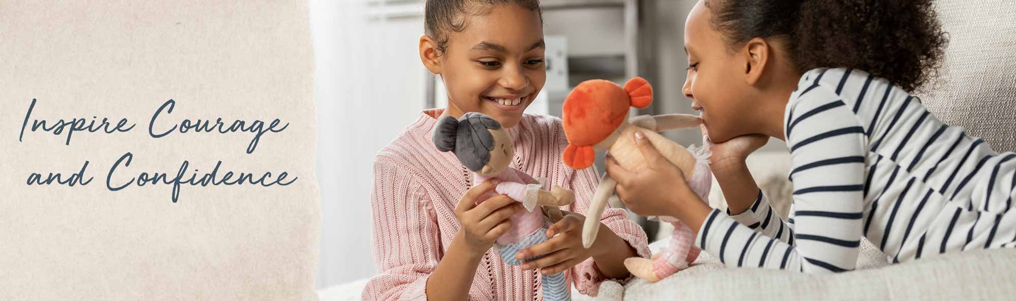 Inspire Courage and Confidence. Young girl playing with a soft doll that looks like her.