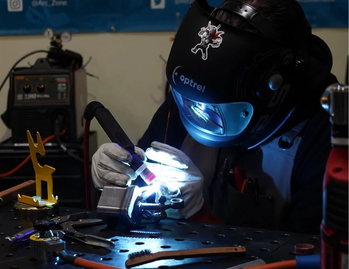 Welder working with a torch in a fabrication shop