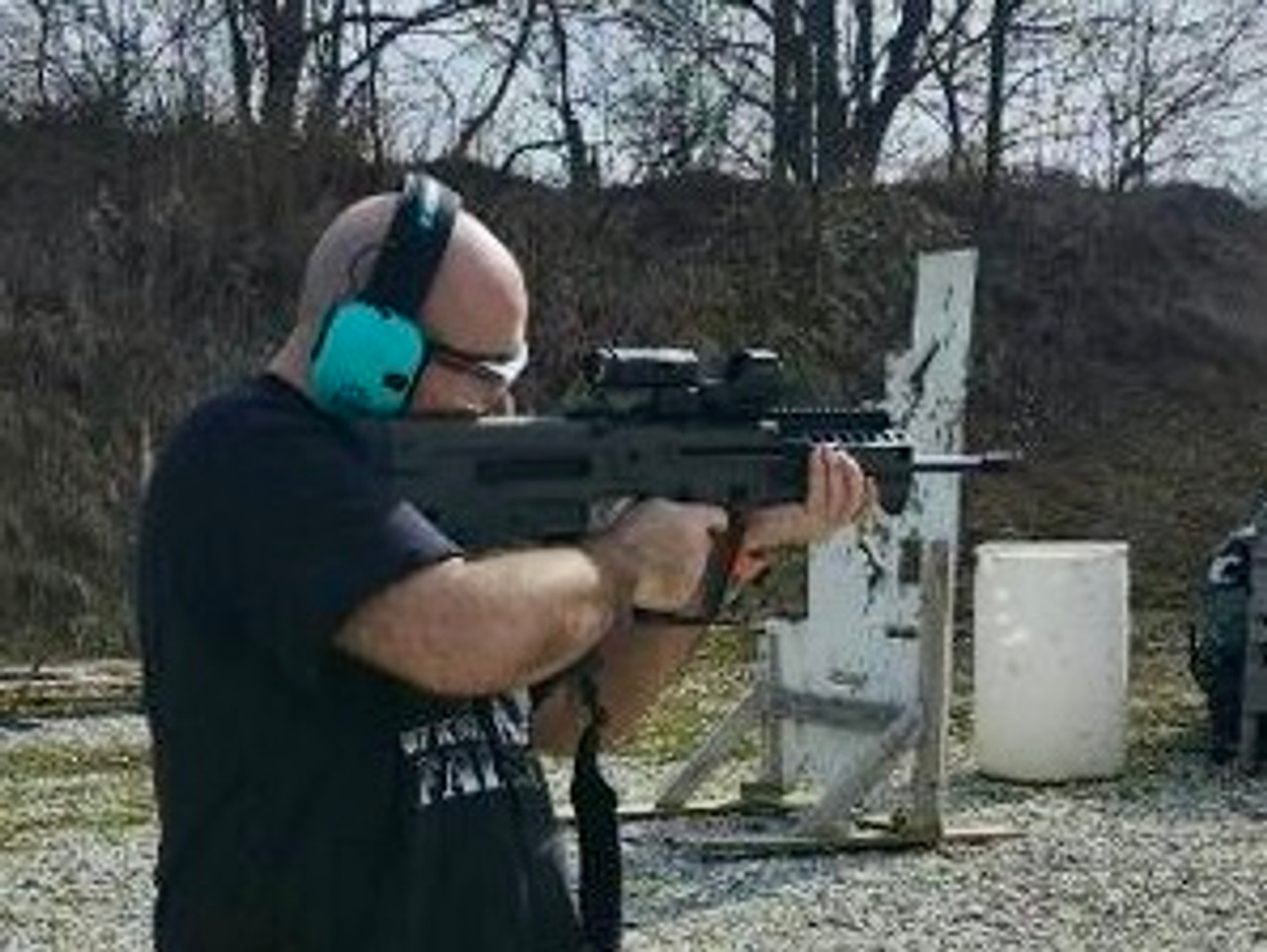 man aiming a rifle