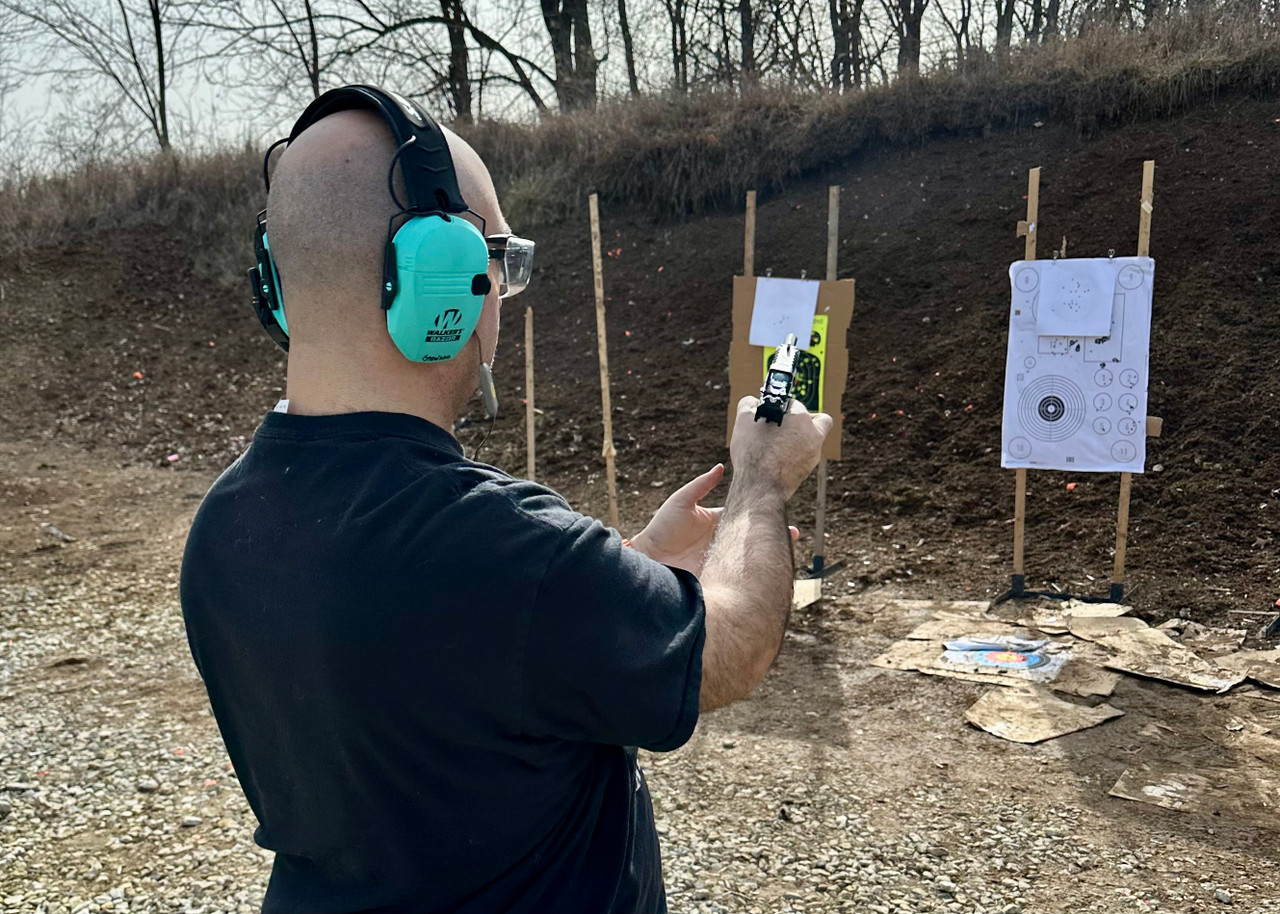 man reloading a pistol