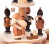 Authentic German Pyramids ON SALE! | Features handcarved Santa with 3 children holding lanterns on the lower turntable, 2 merchants with tray of trinkets on the upper turntable, intricate trees throughout, and 4 premium brass tealight candle holders. USE: Place the candle in the designated holders on the pyramid. Heat from the candle will slowly cause the blades to rotate. | 2-Tier Lantern Children and Merchants, 9" 085/P/530/D | Handmade in the Erzgebirge region of Seiffen, Germany | Lindenhaus Imports in Helen, Ga