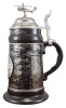 Authentic German Steins ON SALE! | The body of this beer stein is a smooth, black glazed, high-quality stoneware decorated with a platinum wrap around design with names and pictures of 19 historical helicopters (see Description) | The History of the Helicopter, 0.5L 62/MC/43 | Lindenhaus Imports in Helen, GA