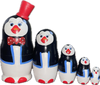 Handcrafted Matryoshka Stackable Nesting Dolls ON SALE! | FRONT: 5 stackable wooden black and white penguin dolls with bright blue eyes, orange beak, a hand-painted red and white polka-dot bow and 3D red hat on the largest piece | Mini Penguin Matryoshka with 3D Red Top Hat, 5" LIND-24 | Lindenhaus Imports in Helen, Ga