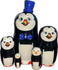 Handcrafted Matryoshka Stackable Nesting Dolls ON SALE! | FRONT: 5 stackable wooden black and white penguin dolls with bright blue eyes, orange beak, a hand-painted blue and white polka-dot bow and 3D blue hat on the largest piece | Penguin Matryoshka with Blue Top Hat, 7" | Lindenhaus Imports in Helen, Ga