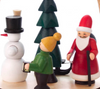 Authentic German Pyramids ON SALE! | Features three handcarved Christmas time figures on the lower turntable: 1 Santa pulling a sled full of presents, 1 Snowman with classic carrot nose and broom stick, and 1 figure leading the way with a handcrafted lantern; hand-painted rotating tree in center with 4 brass candle holders. | 1-Tier Weihnachtszeit (Christmas Time), 10" 085/P/324/D/B | Handmade in the Erzgebirge region of Seiffen, Germany | Lindenhaus Imports in Helen, Ga