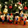 Nutcracker Ornaments ON SALE! | Features traditional King attire with eye-catching glitter accents, gold scepter, lever on back to open and close mouth, gold string attached to top for hanging, and solid base for standing. || King Nutcracker Ornament with Sceptor, 5" G/NTCRKR-1 || Lindenhaus Imports in Helen, Ga