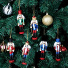 Nutcracker Ornaments ON SALE! | Features 6 traditional nutcracker variations including 2 kings, 3 soldiers, and 1 drummer boy attire with eye-catching glitter accents, lever on back to open and close mouth, gold string attached to top for hanging, and solid base for standing. || 6-pc. Traditional Nutcracker Ornament Set with Glitter, 5" G/NTCRKR || Lindenhaus Imports in Helen, Ga