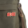 AC/DC Hard Enamel Pin fastened to green backpack.