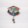 Decorative front view of the Wulfric Chalet German Novelty Quartz Cuckoo Clock on a white shiplap wall