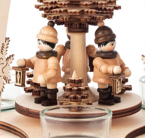 On the rotating disc, three lantern children spin gracefully between three small trees completing the charming scene.