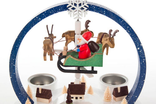 Authentic German Pyramids ON SALE! | Features blue arch with white speckles, flying Santa with 3 handcarved reindeer floating in center, 5 mini houses, intricate trees throughout, and 4 premium metal tealight candle holders. USE: Place the candle in the designated holders on the pyramid. Heat from the candle will slowly cause the blades to rotate. | 2-Tier Winterzauber (Winter Magic), 9" Speckled Arch 085/P/842/D/2 | Handmade in the Erzgebirge region of Seiffen, Germany | Lindenhaus Imports in Helen, Ga Authentic German Pyramids ON SALE! | Features blue arch with white speckles, flying Santa with 3 handcarved reindeer floating in center, 5 mini houses, intricate trees throughout, and 4 premium metal tealight candle holders. USE: Place the candle in the designated holders on the pyramid. Heat from the candle will slowly cause the blades to rotate. | 2-Tier Winterzauber (Winter Magic), 9" Speckled Arch 085/P/842/D/2 | Handmade in the Erzgebirge region of Seiffen, Germany | Lindenhaus Imports in Helen, Ga