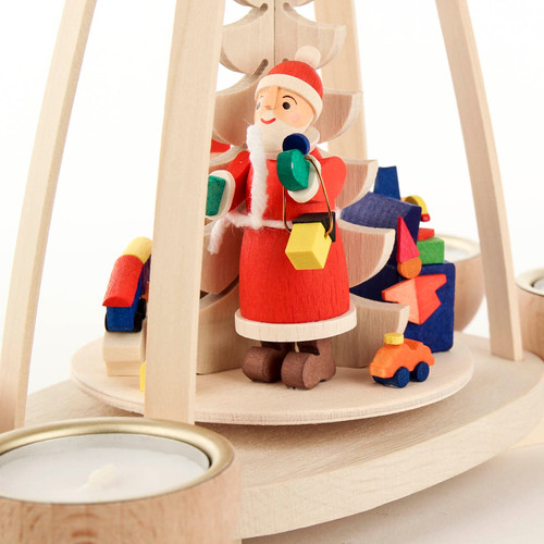 Authentic German Pyramids ON SALE! | Features Santa holding lantern, handcarved toys including train set, bassinet, toy box filled with blocks and yellow duck, intricate rotating tree in center, and 4 premium brass tealight candle holders. USE: Place the candle in the designated holders on the pyramid. Heat from the candle will slowly cause the blades to rotate. | 1-Tier Santa with Toys, 10" 403/P/1093/D | Handmade in the Erzgebirge region of Seiffen, Germany | Lindenhaus Imports in Helen, Ga Authentic German Pyramids ON SALE! | Features Santa holding lantern, handcarved toys including train set, bassinet, toy box filled with blocks and yellow duck, intricate rotating tree in center, and 4 premium brass tealight candle holders. USE: Place the candle in the designated holders on the pyramid. Heat from the candle will slowly cause the blades to rotate. | 1-Tier Santa with Toys, 10" 403/P/1093/D | Handmade in the Erzgebirge region of Seiffen, Germany | Lindenhaus Imports in Helen, Ga
