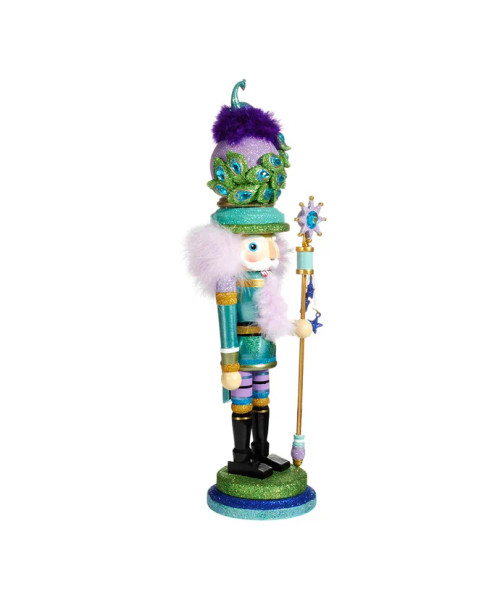Partial front/side view features blue, purple, green, and gold detailing topped off with a peacock perched on the hat. Partial front/side view features blue, purple, green, and gold detailing topped off with a peacock perched on the hat.