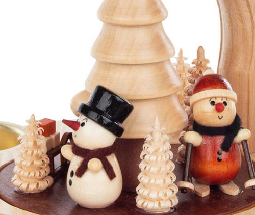 Classic Snowman with carrot nose and 1 Snowman with skis. Intricate rotating tree in center with 4 brass candle holders.