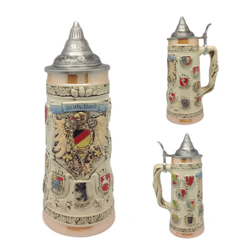 1-liter Deutschland COA Beer Stein features multiple detailed Coat of Arms (COA) from medieval Germany. It is topped with an ornate metal lid and features a colorful depiction of a beautifully engraved medieval eagle at its center. S4223 1-liter Deutschland COA Beer Stein features multiple detailed Coat of Arms (COA) from medieval Germany. It is topped with an ornate metal lid and features a colorful depiction of a beautifully engraved medieval eagle at its center. S4223