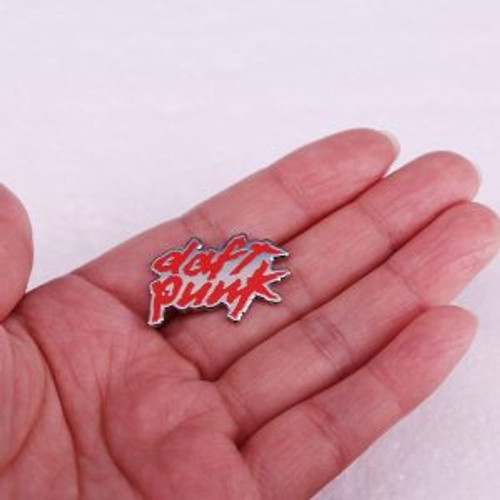 Daft Punk pin lying flat in palm of hand. Daft Punk pin lying flat in palm of hand.