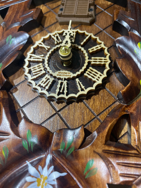 Close up view of wooden dial and numerals with "Made in Germany" carved in the middle of dial Close up view of wooden dial and numerals with "Made in Germany" carved in the middle of dial